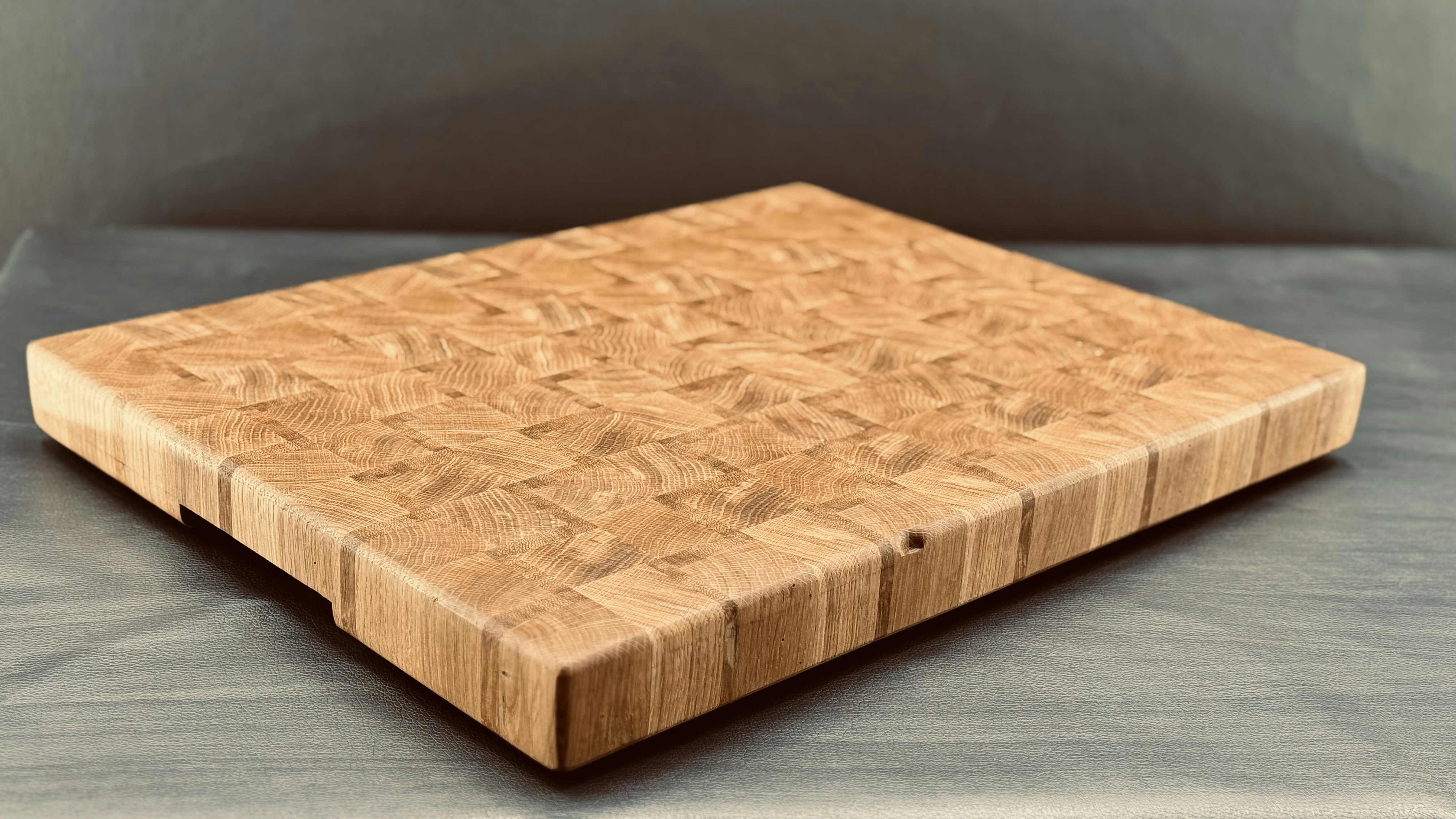 Close-up of a handmade wooden end-grain cutting board showing rich wood grain texture