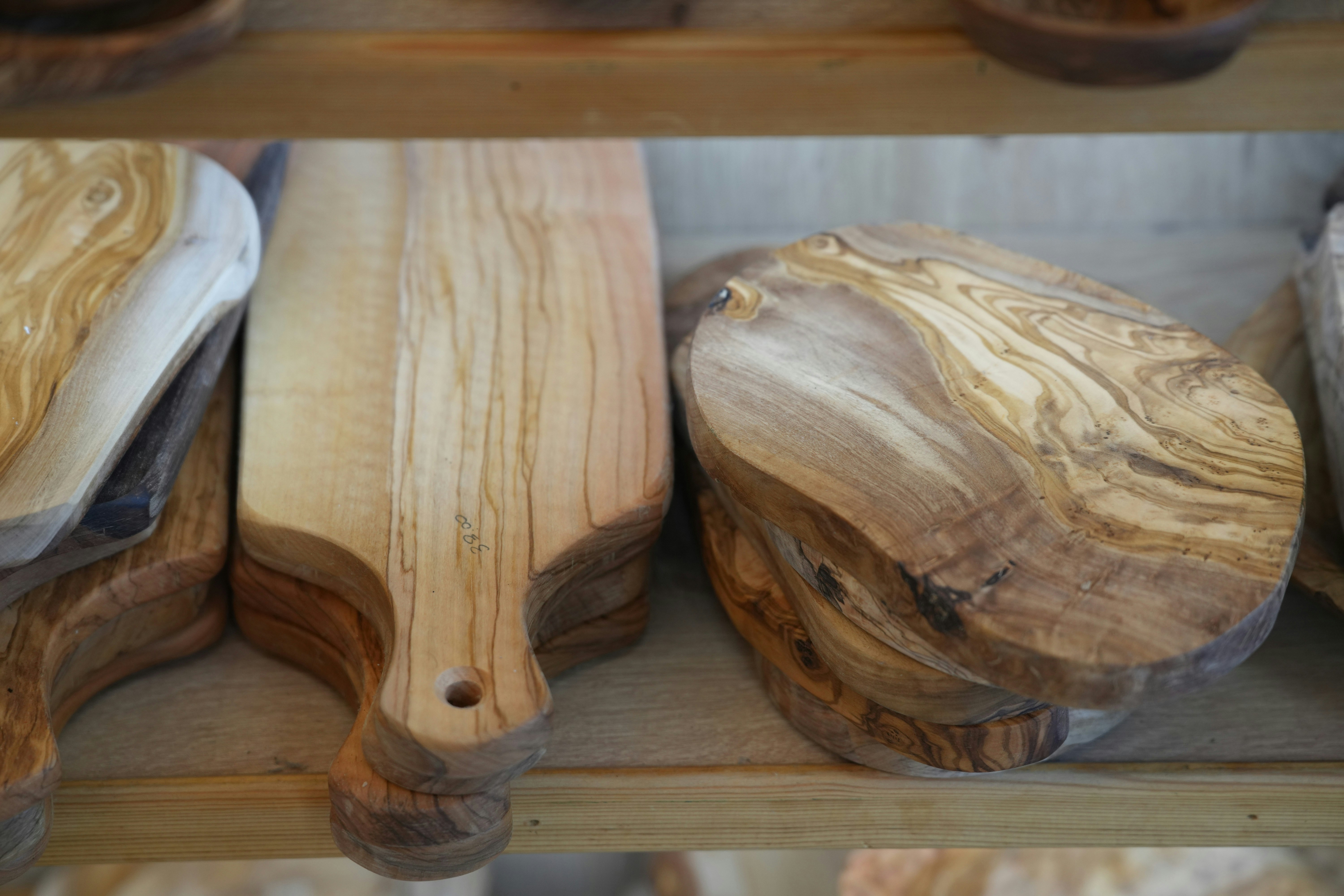 Close-up of handmade wooden cutting boards showing natural wood grain patterns