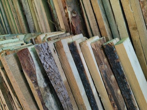 Stack of hardwood lumber boards in varied tones