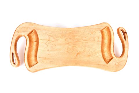 A clean maple wood cutting board on a kitchen counter, showing natural grain and smooth surface