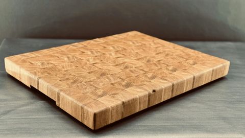 Close-up of an end-grain cutting board showing layered natural wood grain texture